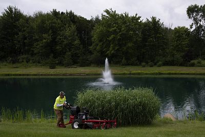 Turfscape Inc. Landscape Technician Alexis Morales, an H-2B visa employee, mows grass at the Tara at Barrington Estates subdivision in Aurora, Ohio, on Aug. 1, 2018. Founder and president of Turfscape Inc., George Hohman, says that his business has been suffering because of the visa shortage that limits the amount of foreign workers he is able to hire. Rachel Woolf for NBC News