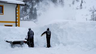 Image: Workers remove snow after a blizzard at the Obertauern ski resort in