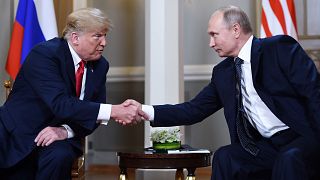 Image: Vladimir Putin  and Donald Trump shake hands before a meeting in Hel