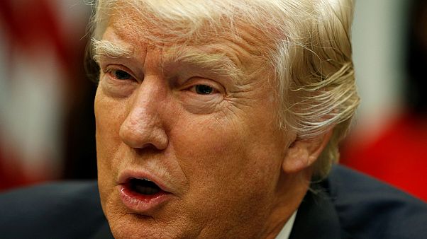 Poll says Americans deeply divided over Trump's performance Poll says Americans deeply divided over Trump's performance