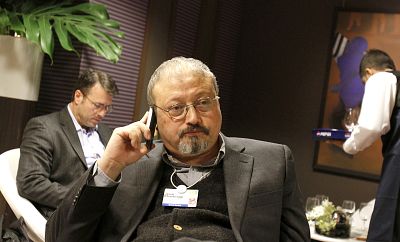 Saudi Arabian journalist Jamal Khashoggi talks on his cell phone at the World Economic Forum in Davos, Switzerland on Jan. 29, 2011.