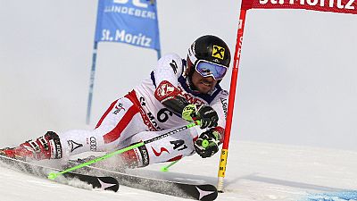 Hirscher seals giant slalom world title, as low-flying plane slices camera cable