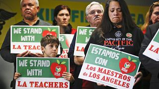 Student Leo Rittner Solomon, 6, and parent Hilda Rodriguez Guzman, right, r