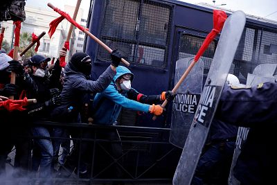 Protesters clash with riot police during a demonstration of Greek school teachers outside the parliament building against government plans to change hiring procedures in the public sector in Athens, Greece on January 14, 2019.
