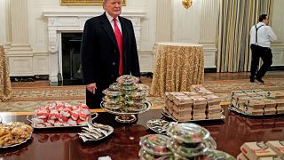 Image: U.S. President Donald Trump speaks in front of fast food provided fo