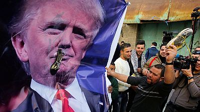 Palestinian protesters throw shoes "at Trump's face"
