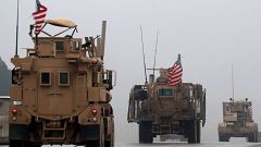 Image: A line of US military vehicles in Syria's northern city of Manbij