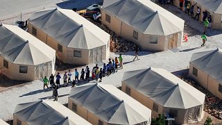 Image: Immigrant children housed in a tent encampment under the new "zero t