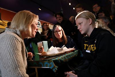Sen. Kirsten Gillibrand, D-N.Y., talks to customers Jeanette Hopkins and Chloe McClure, 15, both of Sioux City, at the Pierce Street Coffee Works in Sioux City, Iowa, on Jan. 18, 2019.