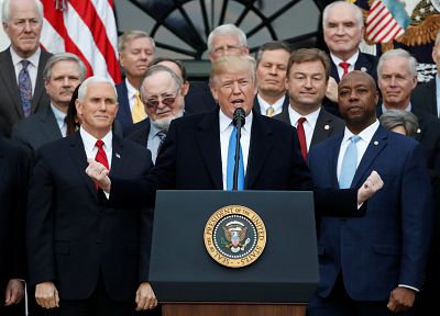 President Donald Trump speaks flanked by Vice President Mike Pence and Senator Tim Scott, right, at the White House on Dec. 20, 2017.