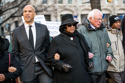 Sen. Bernie Sanders, I -Vt., right, president of the South Carolina NAACP chapter, Brenda Murphy, center, and Sen. Cory Booker, D-N.J., march down Main St. to the Statehouse in commemoration of Martin Luther King Jr. Day on Jan. 21, 2019, in Columbia, S.C.