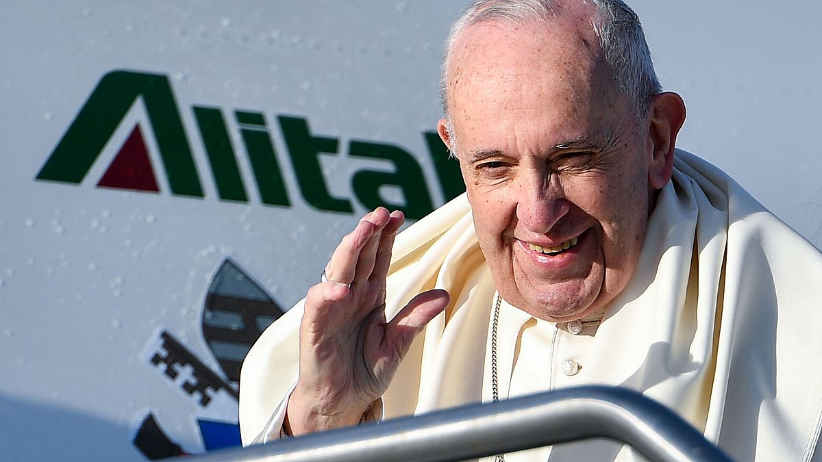 Image: Pope Francis waves before taking the plane to participate to the Wor