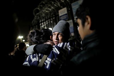 An unaccompanied minor, part of a caravan of thousands from Central America, reacts as he is allowed to enter the United States to apply for asylum at the Otay Mesa port of entry on Dec. 17, 2018.