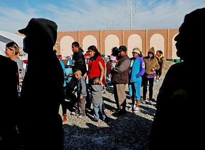Migrants wait for food at a camp containing hundreds of Central Americans hoping to seek asylum in the U.S. on Dec. 12, 2018, in Tijuana, Mexico.