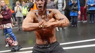 Oil protester performs Haka outside conference