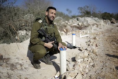 Lt. Col. Avshalom Dadon stands over one of the hundreds of pipes the Israeli military drove into the ground to find tunnels running across the border from Lebanon.