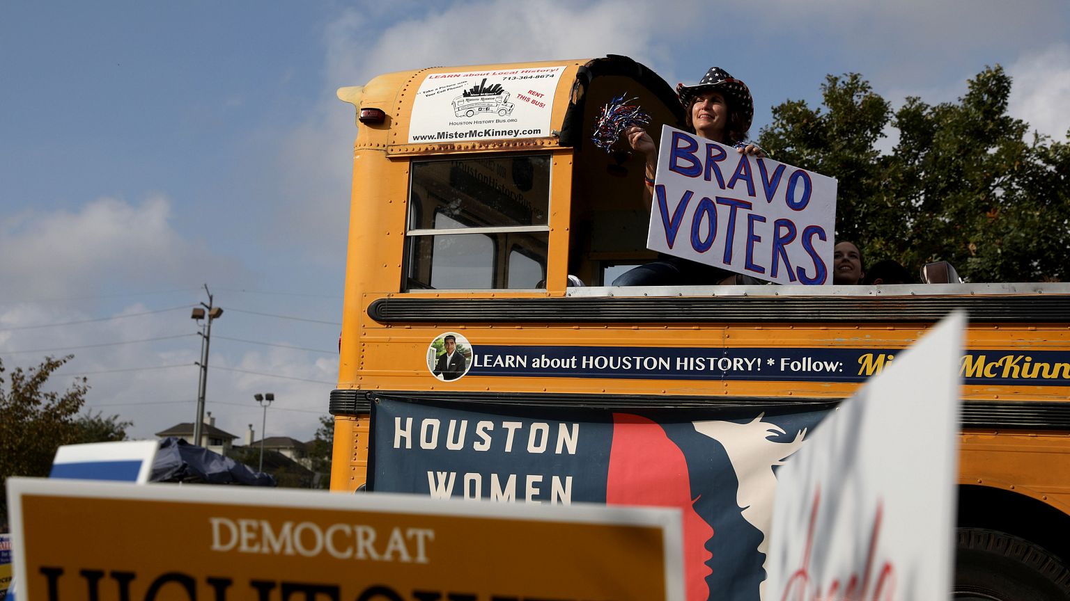 Image: A woman shows support for voters outside the Metropolitan Multi-Serv
