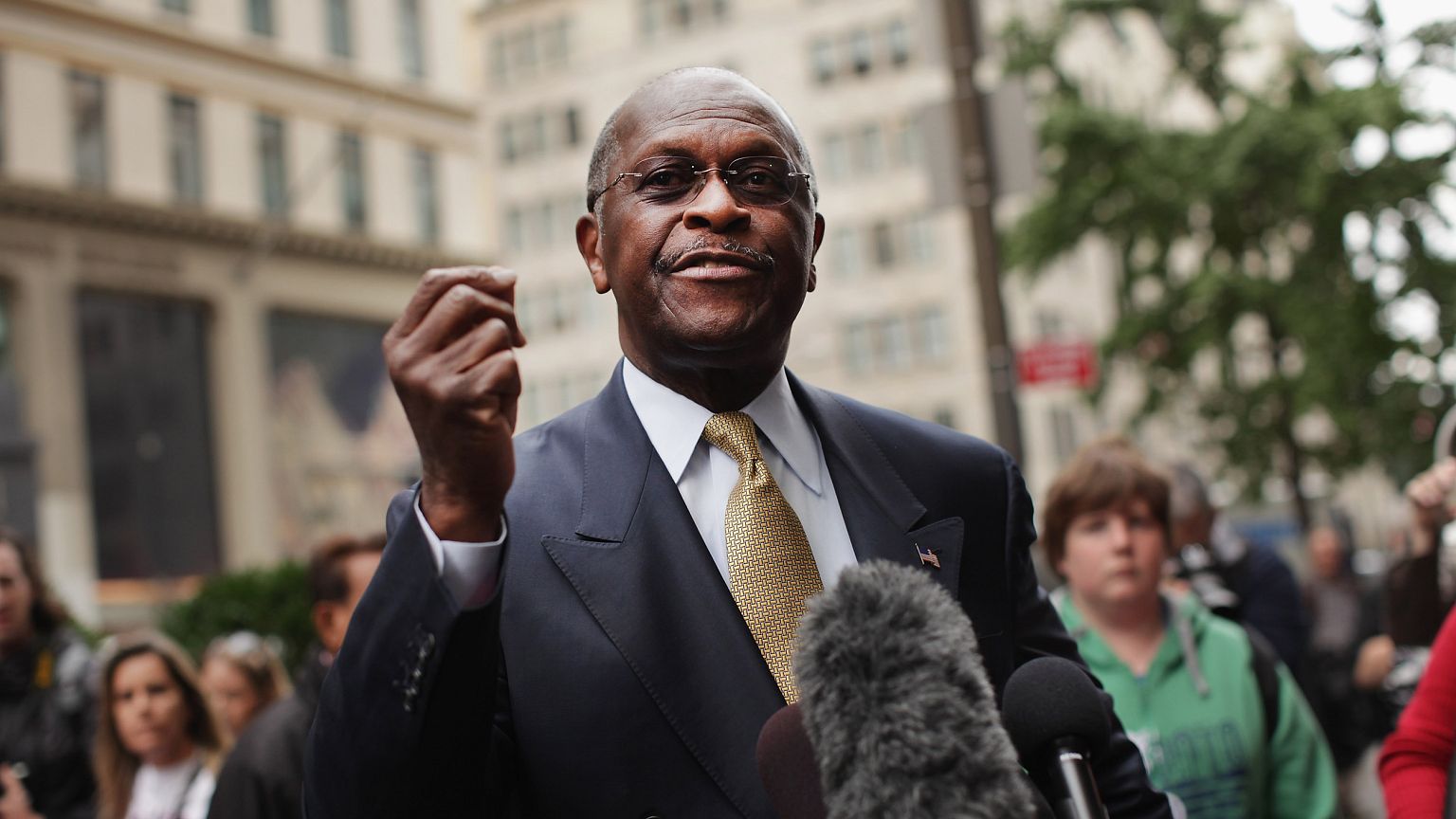Image: Herman Cain speaks to the media outside Trump Tower before a meeting