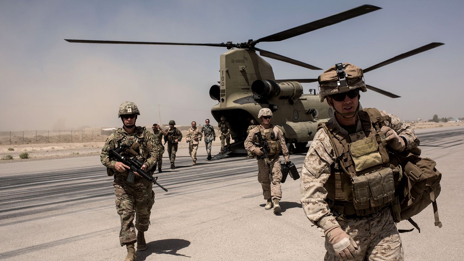 Image: U.S. troops walk off a helicopter at Camp Bost in Helmand Province, 
