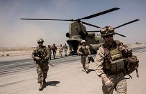 Image: U.S. troops walk off a helicopter at Camp Bost in Helmand Province, 