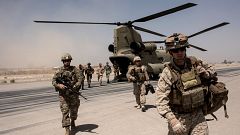 Image: U.S. troops walk off a helicopter at Camp Bost in Helmand Province, 