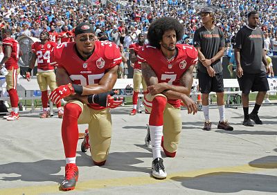 San Francisco 49ers\' Colin Kaepernick, right, and Eric Reid kneel during the national anthem before an NFL game against the Carolina Panthers on Sept. 18, 2016, in Charlotte, North Carolina.