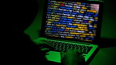 Image: A person sits in front of a computer screen