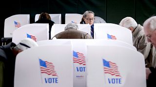 Image: People cast their ballots at a community center during early voting 