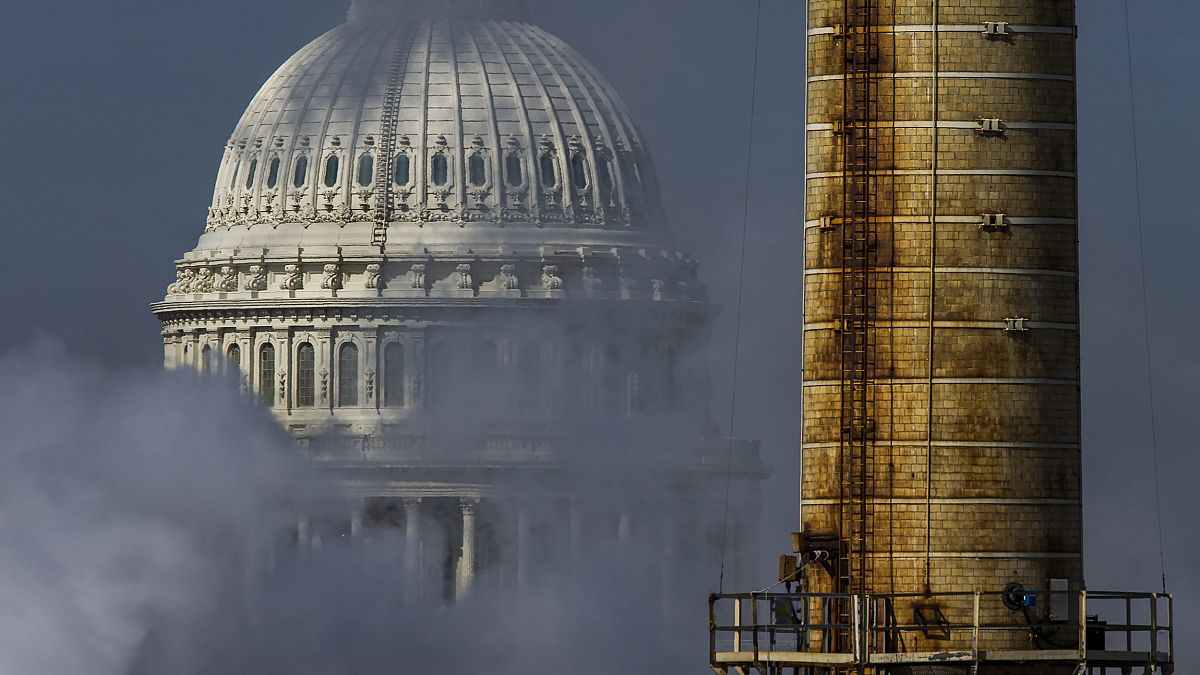 Image: The dome of the U.S. Capitol is seen behind the emissions, and a smo