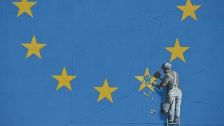 Banksy shows workman removing star from EU flag