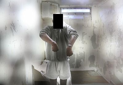 An inmate shows self-inflicted lacerations inside his solitary confinement cell in E-Wing. The inmate\'s face was redacted by Haney in his report. 