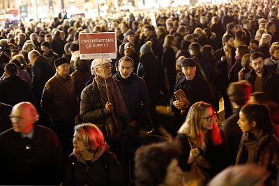 People gather at the Republique square to protest against anti-Semitism, in Paris, France, on Feb. 19, 2019. (Poster reads : Anti-Semitism - That\'s enough.)