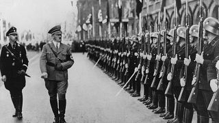 Image: Adolf Hitler and the head of the SS, Heinrich Himmler, walking past 