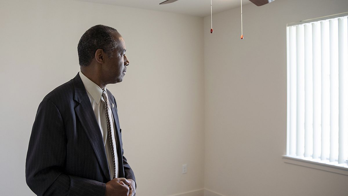 Image: Housing and Urban Development Secretary Ben Carson stands in an empt