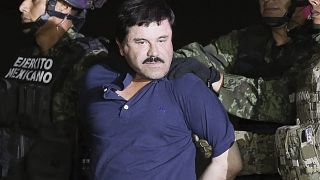 Joaquin "El Chapo" Guzman is escorted by authorities after his detention in