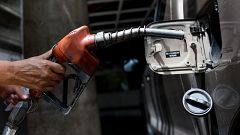 Image: An employee pumps gas into a car in Caracas, Venezuela, on Aug. 17, 