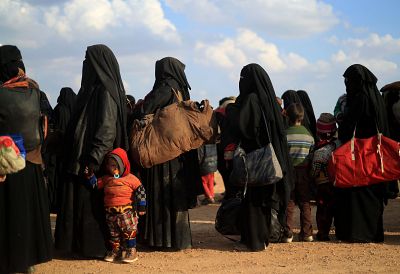 Women and children who fled the Islamic State\'s last embattled holdout of Baghouz, Syria wait to evacuate the area on Feb. 22.