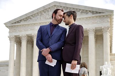 David Mullins and Charlie Craig outside the U.S. Supreme Court on Dec. 5, 2017 in Washington. Craig and Mullins filed a complaint with the commission in 2012 after conservative Christian baker Jack Phillips refused to sell them a wedding cake for their same-sex ceremony.