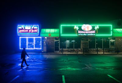 A man walks past Iraqi storefronts in Sterling Heights, Michigan, on March 26, 2017.