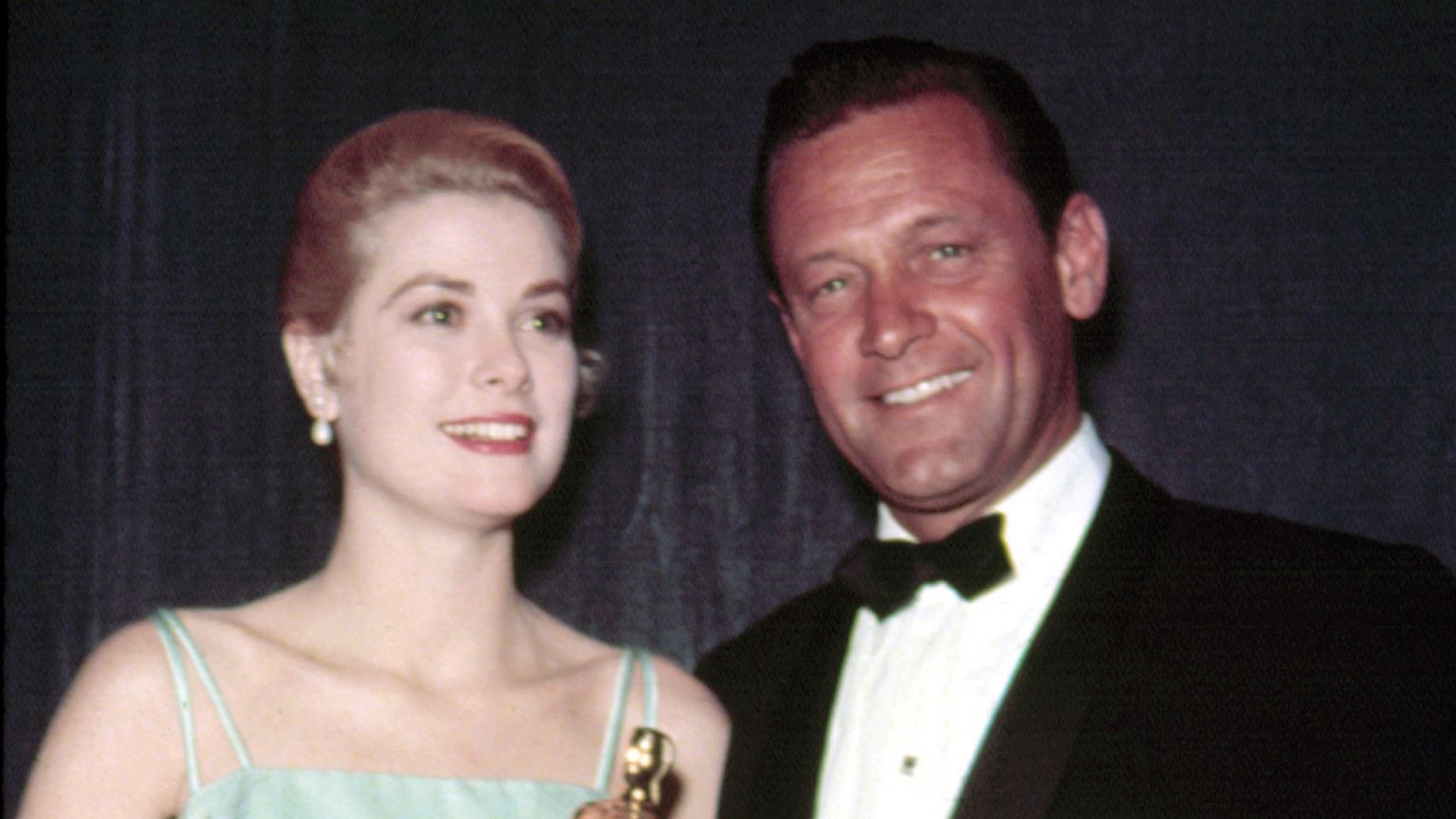 1954: Best Actress GRACE KELLY [The Country Girl] accepts Oscar from the pr
