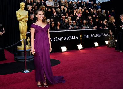 Natalie Portman poses while pregnant at the Oscars in 2011.
