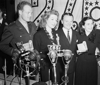 Green Garson, second from left, wore a stylish peplum suit to accept her award. 