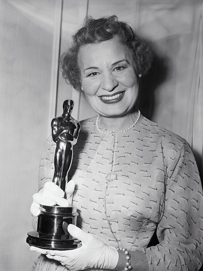 Booth wore a patterned dress to accept the award. 