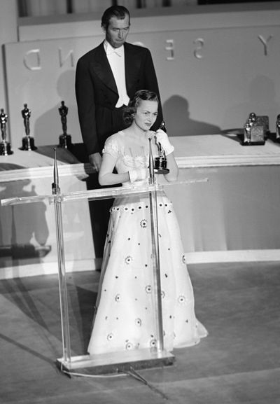 Olivia De Havilland accepts her award for best actress onstage.