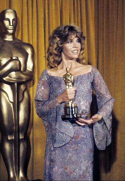 Jane Fonda poses in a flowy gown after receiving her Academy Award.
