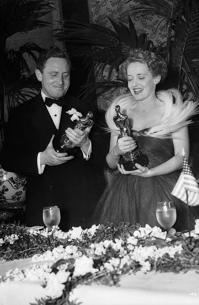 Spencer Tracy and Bette Davis accept their awards for best actor and best actress at the 11th Annual Academy Awards.