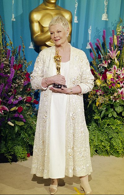 Judi Dench holds the Oscar she won for best supporting actress. 