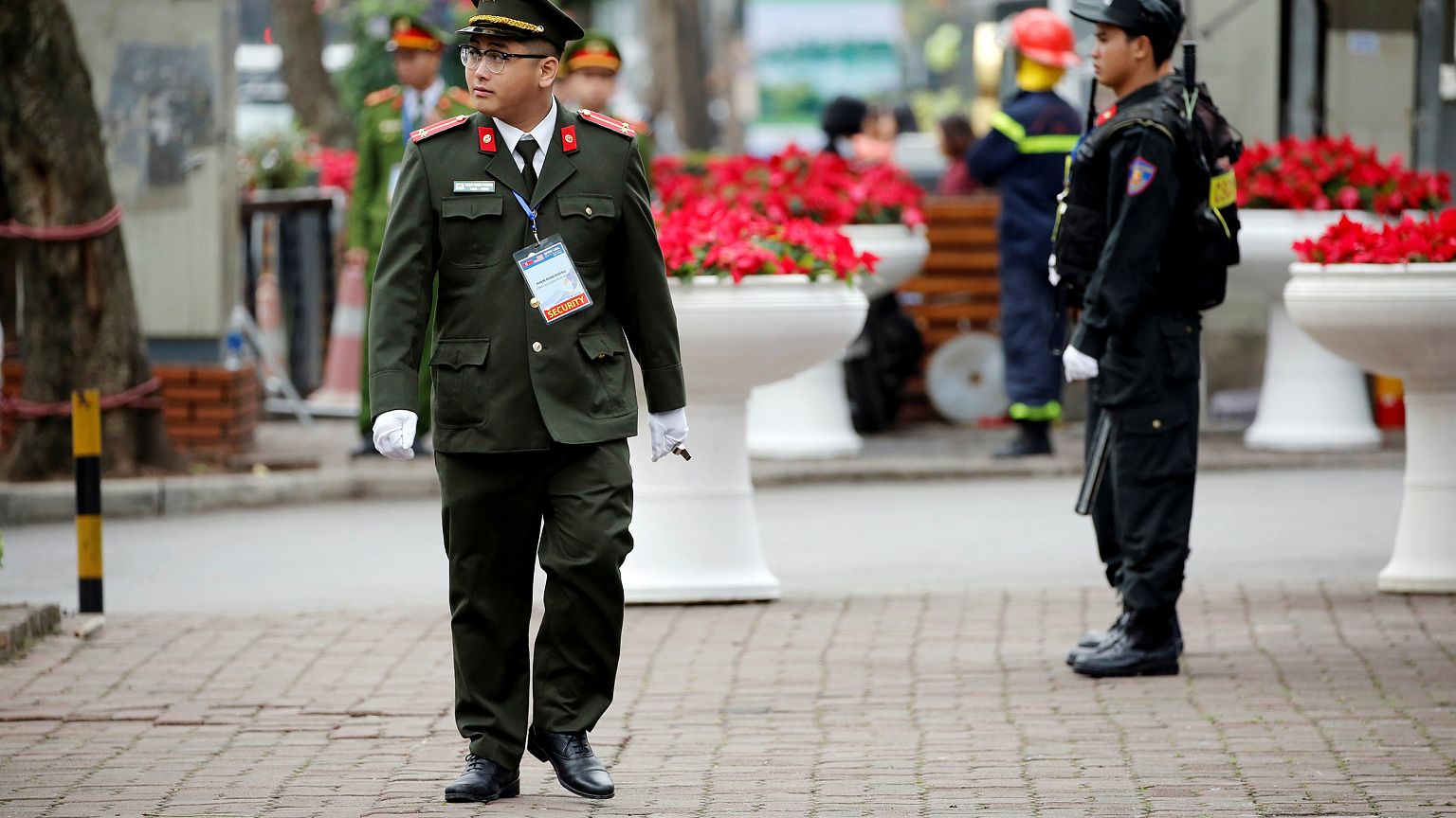 Image: Security officers stand guard at Melia Hotel before the Trump-Kim su