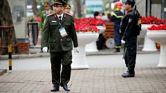 Image: Security officers stand guard at Melia Hotel before the Trump-Kim su