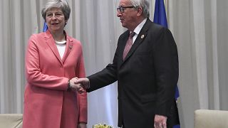 Image: British Prime Minister Theresa May shakes hands with European Commis